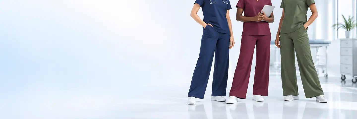 Women wearing navy, wine, and olive wide-leg scrub pants